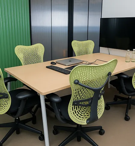 Meeting room setup with projector and seating at Wibes