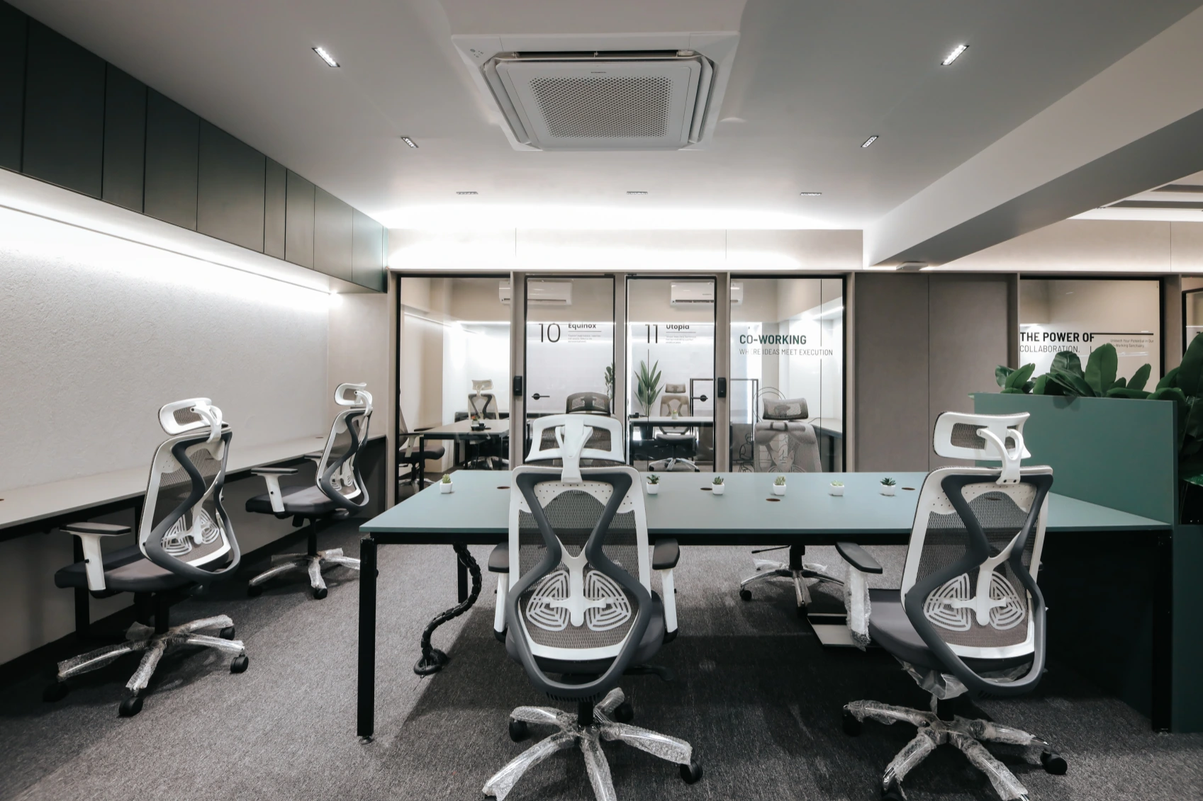 Intimate meeting room with round table and lime green ergonomic chairs