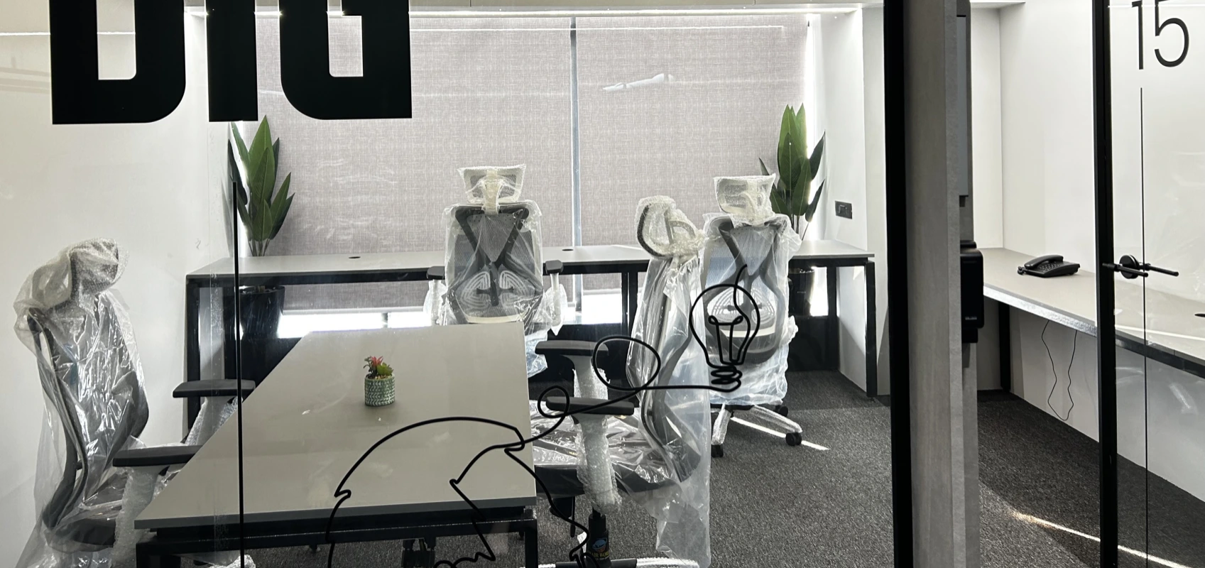 Individual workstation with standing desk and modern office setup