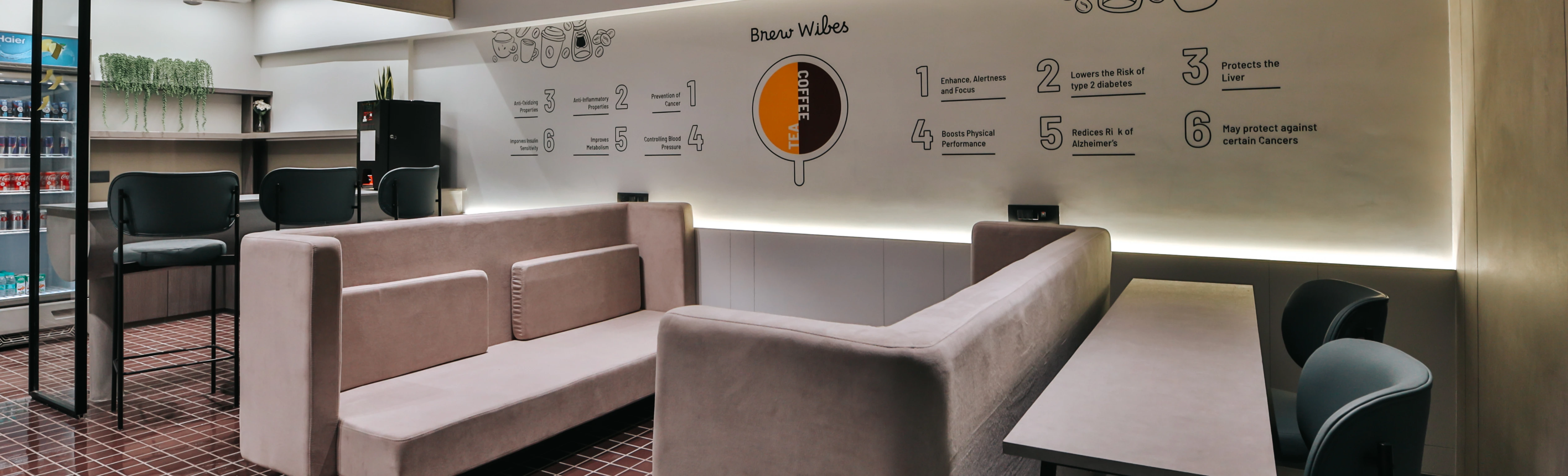 Office break area with orange seating and casual dining setup